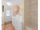 Bright laundry room with storage shelves, washer, dryer, back door, and wood flooring at 1746 Fox Hill Dr, Lakeland, FL 33810