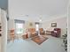 Bright living room features comfortable seating, natural light, and ceiling fan, creating a cozy gathering space at 1746 Fox Hill Dr, Lakeland, FL 33810