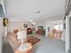 Spacious living room with large windows, ceiling fan, comfortable seating, and views into the kitchen and dining areas at 1746 Fox Hill Dr, Lakeland, FL 33810
