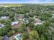 A lovely neighborhood boasts a home with a pool, green grass, and surrounded by lush trees at 195 E Conant St, Bartow, FL 33830