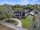 A stunning home is showcased with a long driveway, well-manicured lawn and beautiful mature trees at 195 E Conant St, Bartow, FL 33830