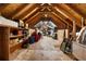 Unfinished attic space with exposed beams, plywood floor and storage shelving, offering a rustic aesthetic at 195 E Conant St, Bartow, FL 33830