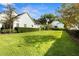 Expansive back yard showing lawn and partial view of home and detached garage at 195 E Conant St, Bartow, FL 33830