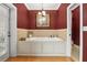 This elegant soaking tub sits under a decorative light fixture with a large decorative painting at 195 E Conant St, Bartow, FL 33830