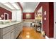 This elegant bathroom has dual sinks with granite counters, hardwood floors, and a soaking tub at 195 E Conant St, Bartow, FL 33830