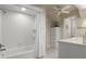 Bright bathroom with white tiled shower-tub combination at 195 E Conant St, Bartow, FL 33830