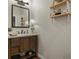 Bathroom with a wooden vanity, modern mirror, and a decorative wooden shelf with plants at 195 E Conant St, Bartow, FL 33830