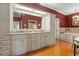 A bathroom featuring dual sinks with granite counters, hardwood floors, and a soaking tub at 195 E Conant St, Bartow, FL 33830