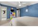 A blue bedroom with a neutral carpet and a large bed featuring a ceiling fan at 195 E Conant St, Bartow, FL 33830