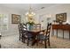 Charming dining area featuring a wooden table, floral accents, and natural lighting at 195 E Conant St, Bartow, FL 33830