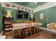 Dining room with hardwood floors, vintage record decor, and a hanging swing providing a unique seating option at 195 E Conant St, Bartow, FL 33830