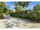 Long driveway lined with trees and bushes leading to a hidden home at 195 E Conant St, Bartow, FL 33830