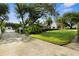 Lush front yard with mature trees and a long driveway leading to a charming home at 195 E Conant St, Bartow, FL 33830