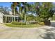 Beautiful home exterior with a circular driveway, pool, and mature landscaping at 195 E Conant St, Bartow, FL 33830