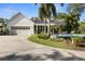 Charming home exterior with a circular pool, lush greenery, and attached garage at 195 E Conant St, Bartow, FL 33830