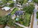 A picturesque house features a luscious, green lawn with mature trees and beautiful landscaping at 195 E Conant St, Bartow, FL 33830