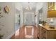 Bright foyer with wood floors, decorative chandelier, and an arched doorway at 195 E Conant St, Bartow, FL 33830