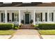 Inviting front entrance featuring a brick pathway, covered porch, and well-maintained landscaping at 195 E Conant St, Bartow, FL 33830