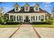 Inviting front exterior featuring a covered porch with rocking chairs and manicured landscaping at 195 E Conant St, Bartow, FL 33830