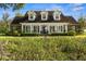 Inviting home featuring a manicured front yard and a charming porch with rocking chairs at 195 E Conant St, Bartow, FL 33830