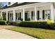 Charming front porch with white columns, rocking chairs, and neat landscaping at 195 E Conant St, Bartow, FL 33830