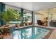 Indoor pool featuring a seating area and views of the outdoor pool at 195 E Conant St, Bartow, FL 33830