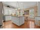 Inviting kitchen boasts a spacious island, granite countertops, and stylish pendant lighting at 195 E Conant St, Bartow, FL 33830