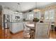 Bright kitchen features white cabinets, stainless steel appliances, and a cozy dining area at 195 E Conant St, Bartow, FL 33830