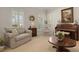 Cozy living room featuring comfortable seating, piano, and many windows at 195 E Conant St, Bartow, FL 33830