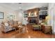 Cozy living room with brick fireplace, built-in shelves, and hardwood floors at 195 E Conant St, Bartow, FL 33830
