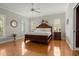 Spacious main bedroom featuring hardwood floors, stylish furnishings, and ample natural light at 195 E Conant St, Bartow, FL 33830