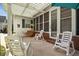 Back patio featuring rocking chairs, lounge seating, and a porch swing at 195 E Conant St, Bartow, FL 33830