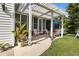 Outdoor patio with pergola, rocking chairs, and view of the well-manicured lawn at 195 E Conant St, Bartow, FL 33830