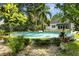 Beautiful pool area surrounded by lush landscaping and mature trees at 195 E Conant St, Bartow, FL 33830