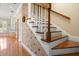 A decorative staircase with hardwood floors and white banisters leading to the second story at 195 E Conant St, Bartow, FL 33830