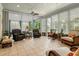 Sunroom featuring comfortable seating and a view of the beautiful pool at 195 E Conant St, Bartow, FL 33830