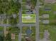 Aerial view of a neighborhood, centering the gray home with a bright green lawn at 2020 Bassedena W Cir, Lakeland, FL 33805