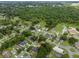 A high angle view showcasing neighborhood homes, surrounding green trees, and a clear view of the neighborhood streets at 2020 Bassedena W Cir, Lakeland, FL 33805