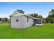 Exterior view of the house showcasing its back with well maintained yard and simple design at 2020 Bassedena W Cir, Lakeland, FL 33805