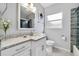 Bright bathroom with granite vanity, shower, modern fixtures, framed mirror, and a frosted window at 2020 Bassedena W Cir, Lakeland, FL 33805