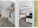 The bedroom shows modern paint, fan and great light with a connecting hallway with a contrasting floor color at 2020 Bassedena W Cir, Lakeland, FL 33805