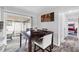 Dining room with dark wood table, white chairs, and sliding glass doors to the backyard patio at 2020 Bassedena W Cir, Lakeland, FL 33805