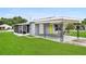 External home view featuring a grey exterior, well-maintained lawn, and covered carport at 2020 Bassedena W Cir, Lakeland, FL 33805