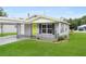 View of the home showcasing its inviting curb appeal with a well-kept lawn and carport at 2020 Bassedena W Cir, Lakeland, FL 33805