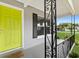 A charming front porch with an ornamental black railing, an accent-colored door, and a neutral-colored exterior at 2020 Bassedena W Cir, Lakeland, FL 33805