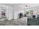Inviting living room with wood floors, ceiling fan, and a large window offering plenty of natural light at 2020 Bassedena W Cir, Lakeland, FL 33805