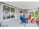 The back patio has a sliding glass door, various chairs, and a view of the backyard at 2020 Bassedena W Cir, Lakeland, FL 33805