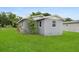 Exterior shot of the house displaying simple landscaping and modern design on the side at 2020 Bassedena W Cir, Lakeland, FL 33805