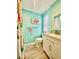 Updated bathroom with modern fixtures, granite countertop, and colorful floral shower curtain at 2055 S Floral Ave # 11, Bartow, FL 33830