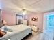 Comfortable bedroom featuring wood-look floors and an ensuite bathroom with matching decor at 2055 S Floral Ave # 11, Bartow, FL 33830
